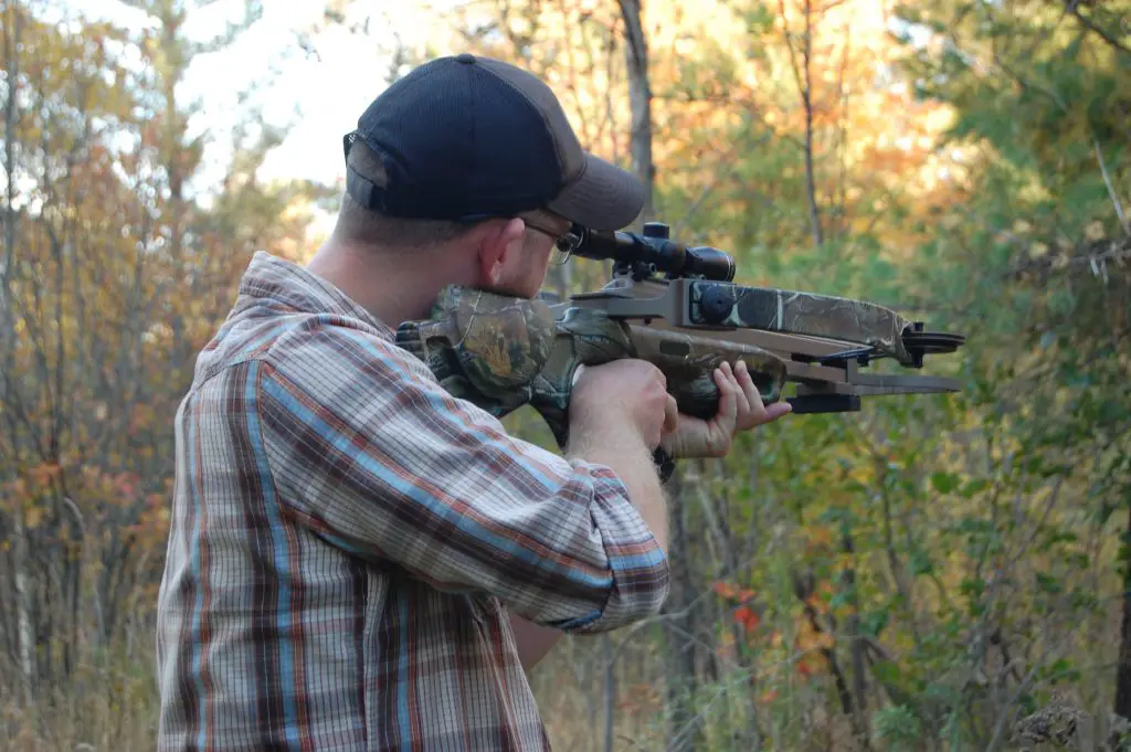  young man holding crossbow